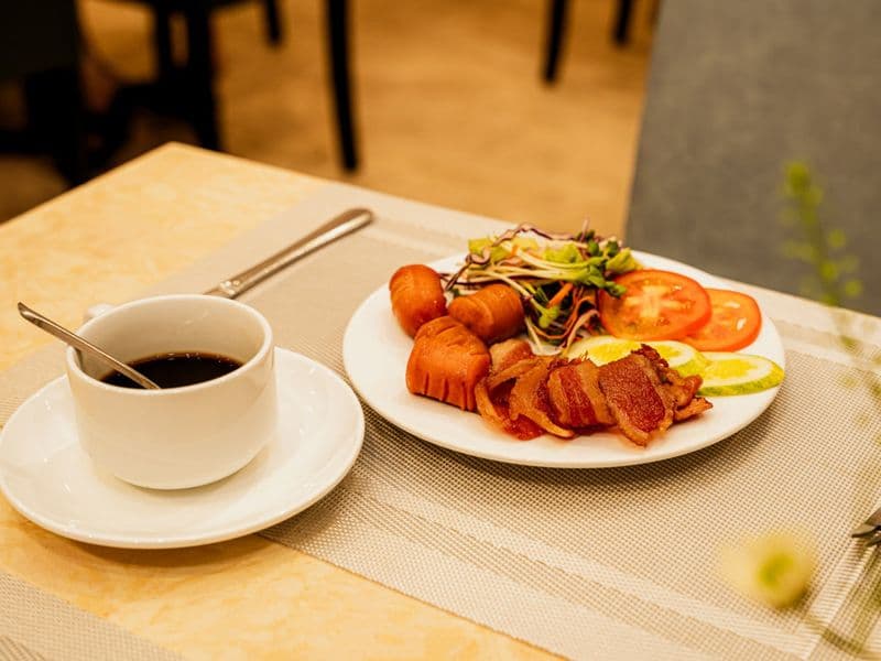 Bữa sáng với cà phê và đĩa món nóng